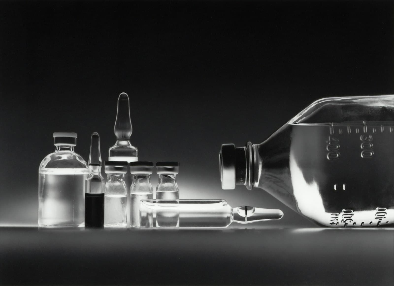 Glass vials and ampoules on a dark background